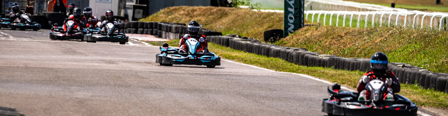 Wide action shot of The Village Fete 2025 go-karting endurance race